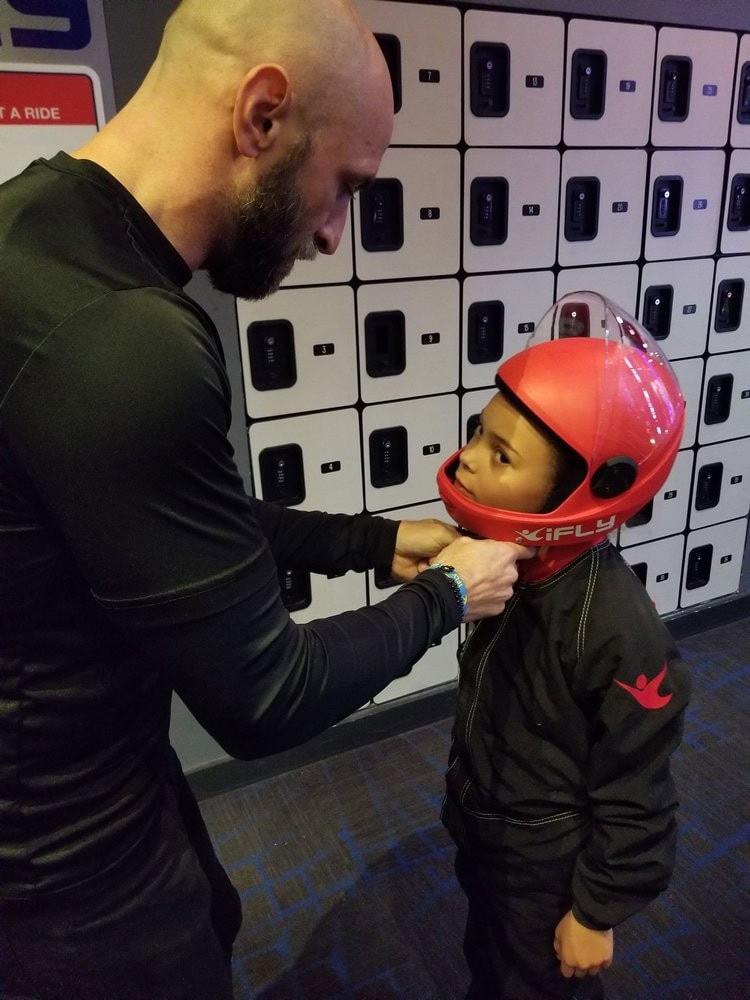 A child suits up with helmet, earplugs, and jumpsuit, showing how safety is the top priority at iFLY. Credit: Courtney B.