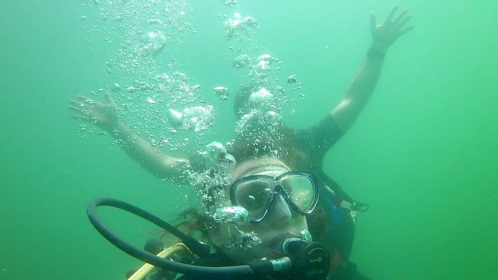 An underwater selfie captures two divers fully geared up beneath the lake’s surface. Credit: Jake “AH0meLEssguy” Harris