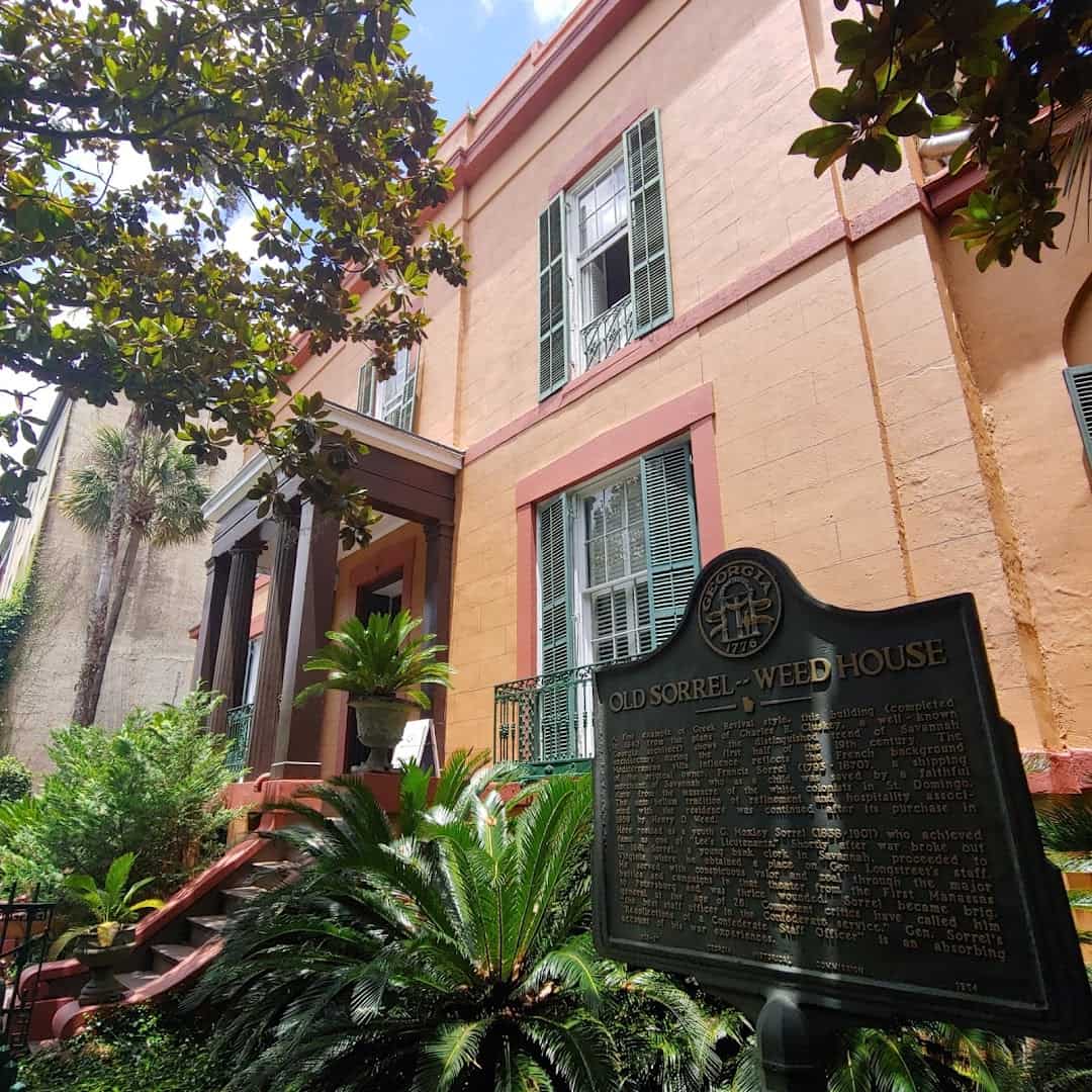 The exterior and historic marker of the Sorrel-Weed House in Savannah, Georgia