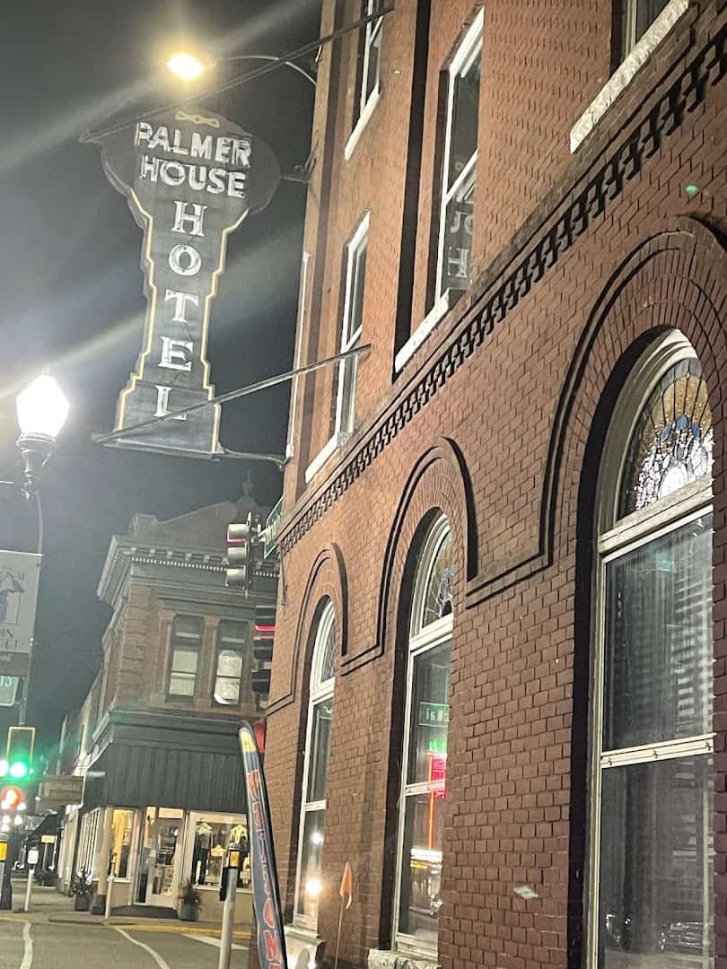 The Palmer House Hotel and its vintage neon sign at night in Sauk Centre, Minnesota