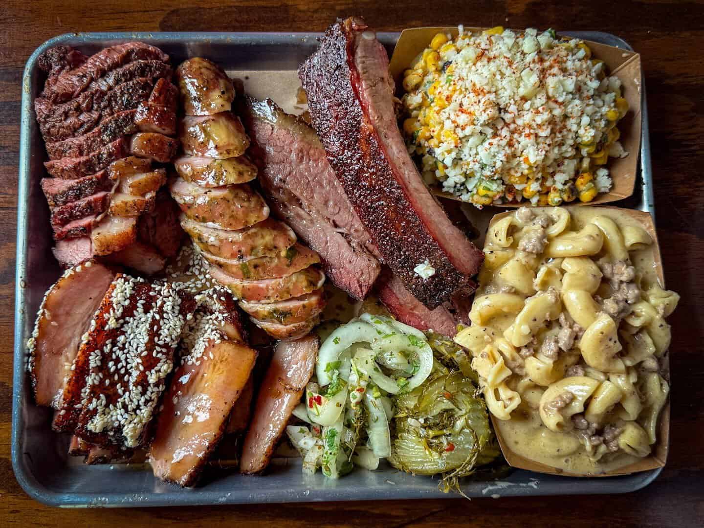 Tray of brisket, ribs, sausage and chicharron mac and cheese at 2M Smokehouse in San Antonio, Texas
