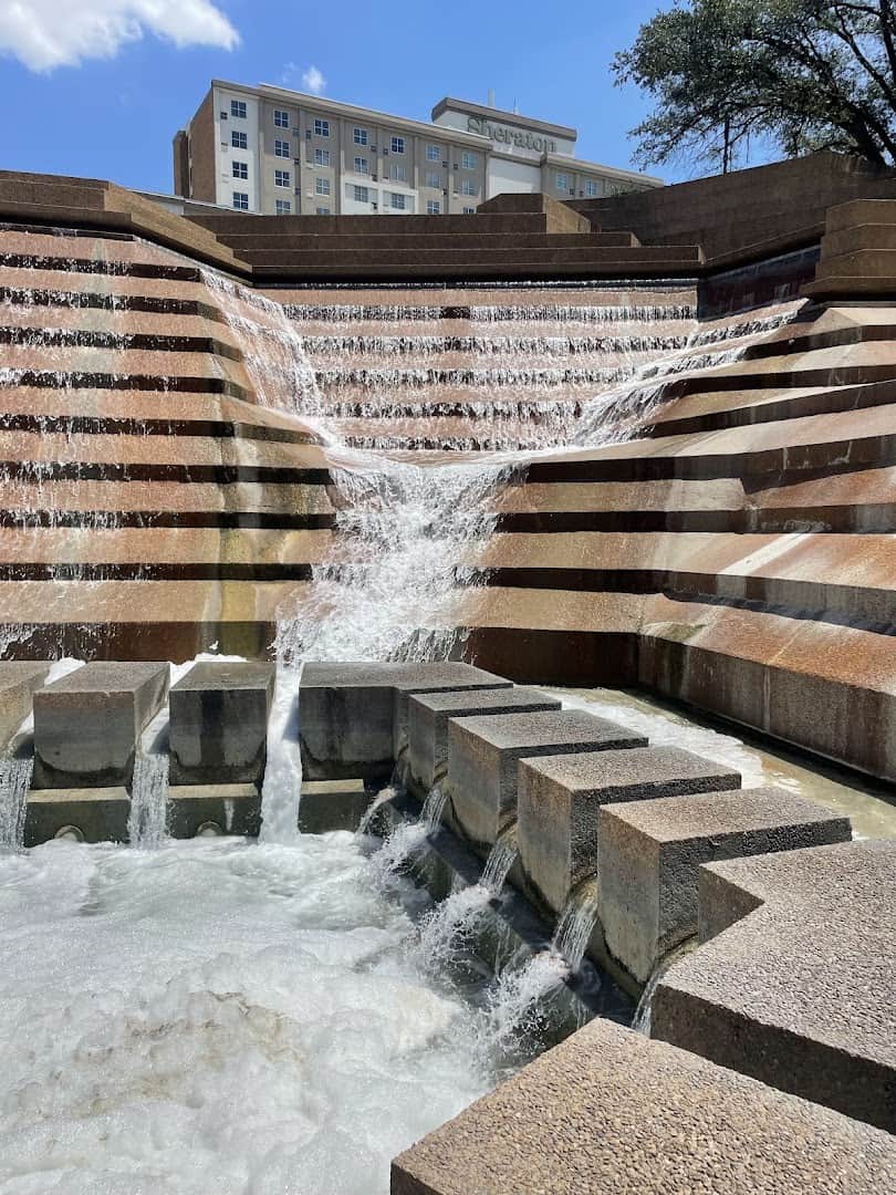 Water crashing down the concrete steps of the Active Pool at the Fort Worth Water Gardens