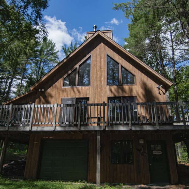 Elevated A-frame cabin among the trees at Adirondack Adventure Base in Paul Smiths, New York