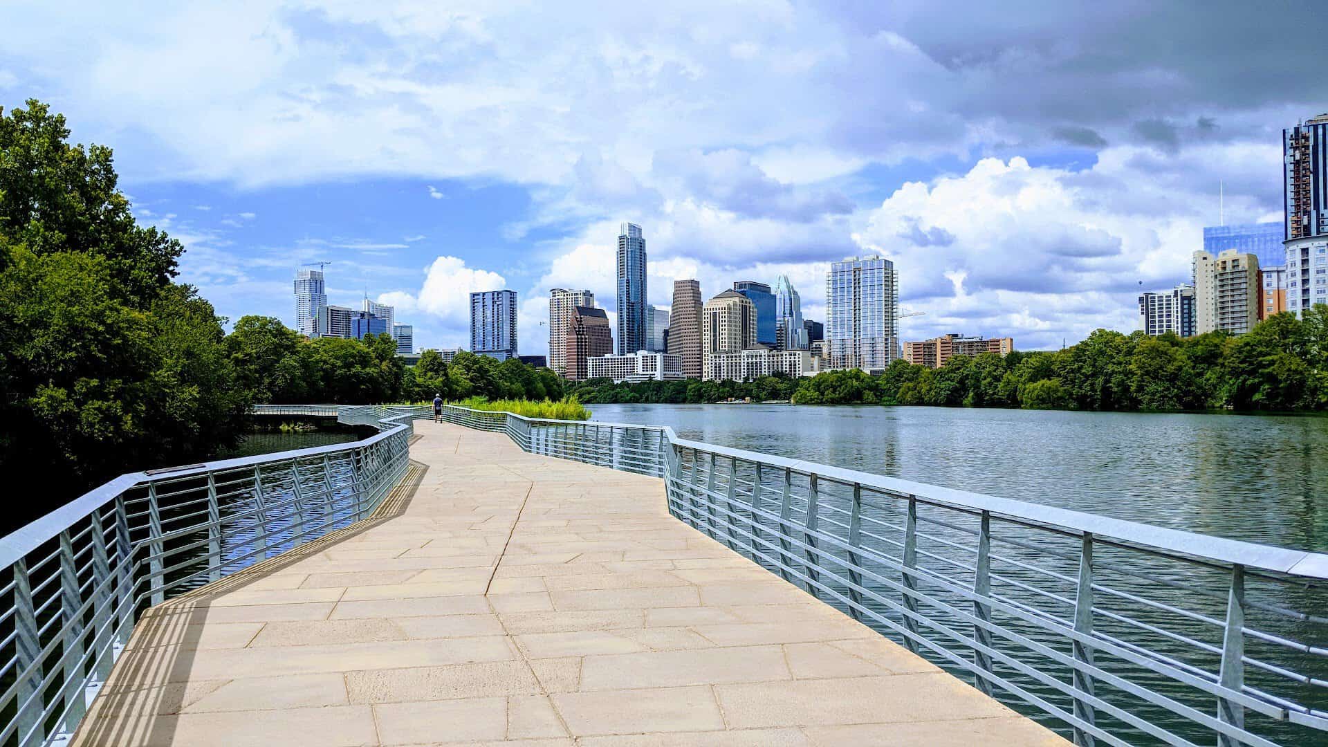 The Butler Trail boardwalk over Lady Bird Lake with the downtown Austin skyline, Texas