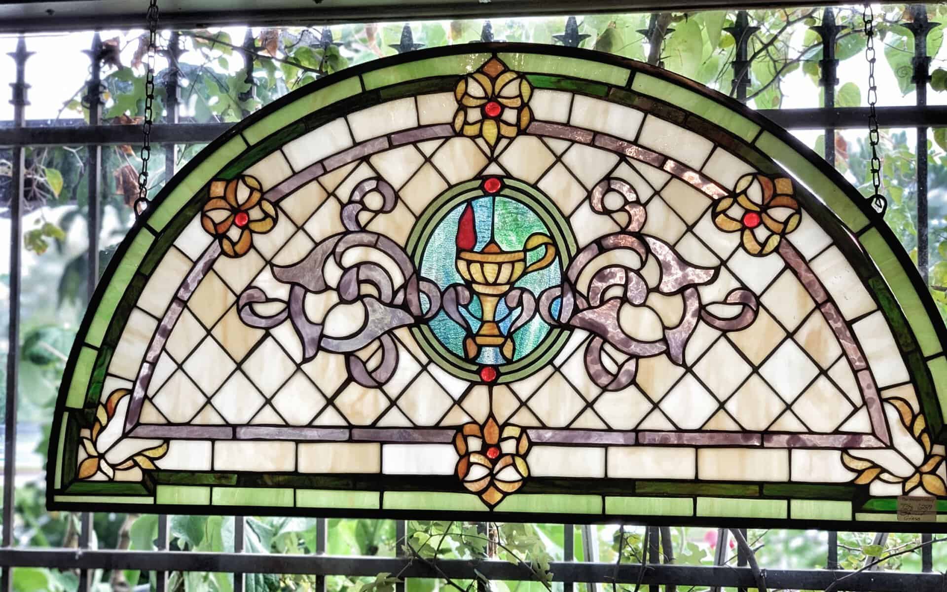 Arched antique stained glass window at The Antique Gallery of Houston in Spring, Texas