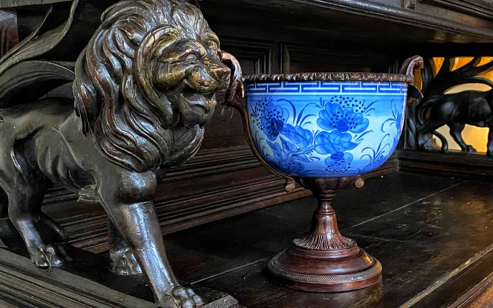 Bronze lion sculpture and blue porcelain vase at The Antique Gallery of Houston in Spring, Texas