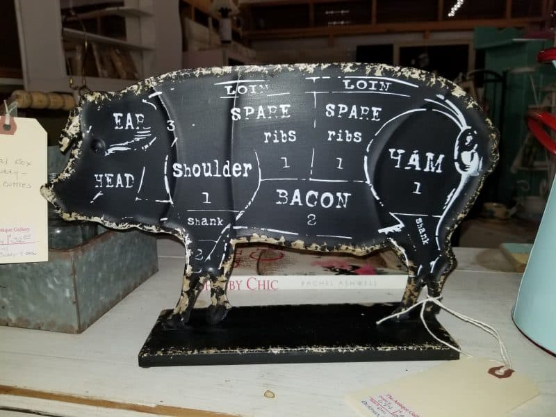 Cast metal butcher-cut pig sign, a quirky decor piece at The Antique Gallery of Houston in Spring, Texas