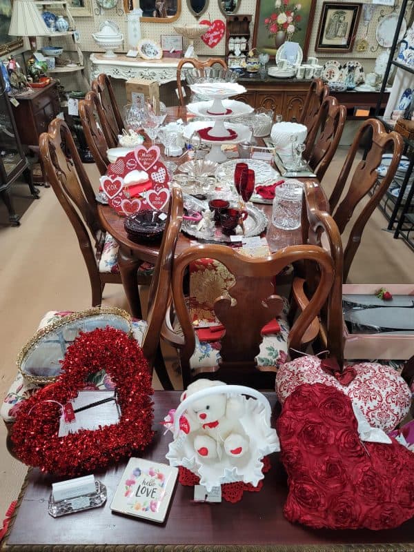 Vintage china and glassware set on a dining table at The Antique Gallery of Houston in Spring, Texas