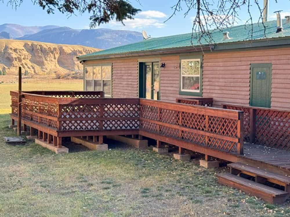 Riverside log cabin with deck at Antlers Rio Grande Lodge in Creede, Colorado