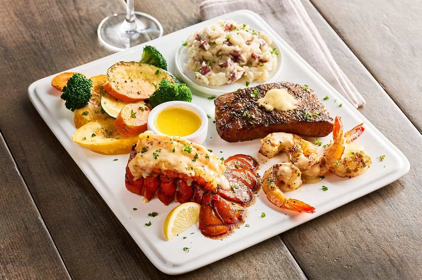Surf and turf plate with salmon, shrimp, lobster and steak at the Aquarium Restaurant in Houston