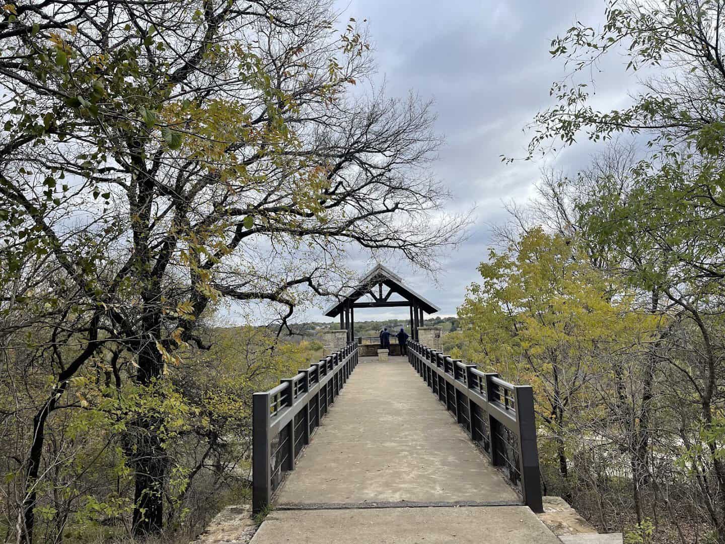 Wooden footbridge on a shaded trail at Arbor Hills Nature Preserve in Plano, Texas