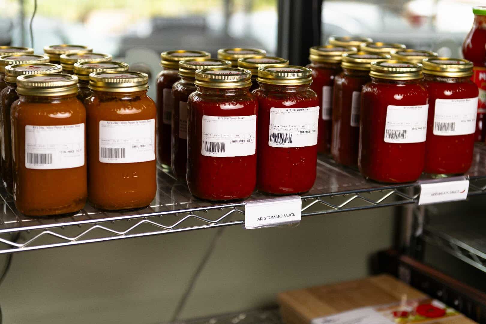 Jars of Ari's house-made tomato and arrabbiata sauce at Ari's Pantry in Dallas
