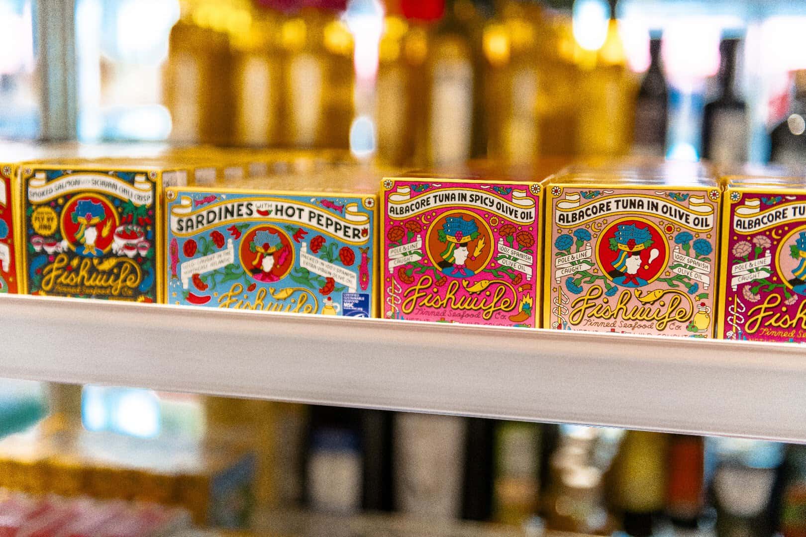 Colorful imported tinned fish on the shelf at Ari's Pantry in Dallas