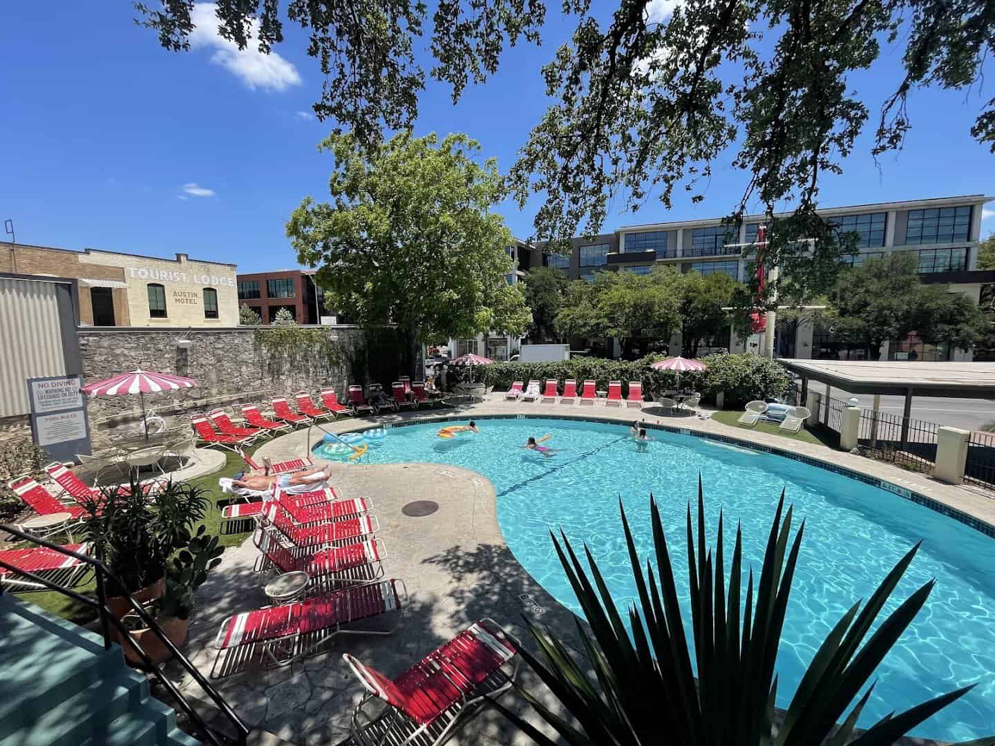 Resort pool with red umbrellas at the Austin Motel on South Congress Avenue in Austin, Texas