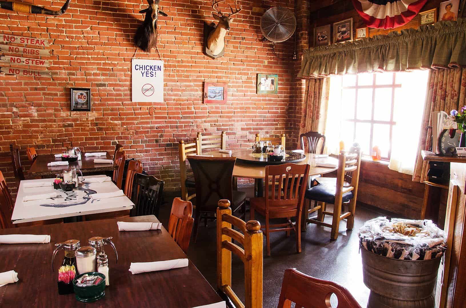 Cozy brick dining room with country decor at Babe's Chicken Dinner House in Roanoke, Texas
