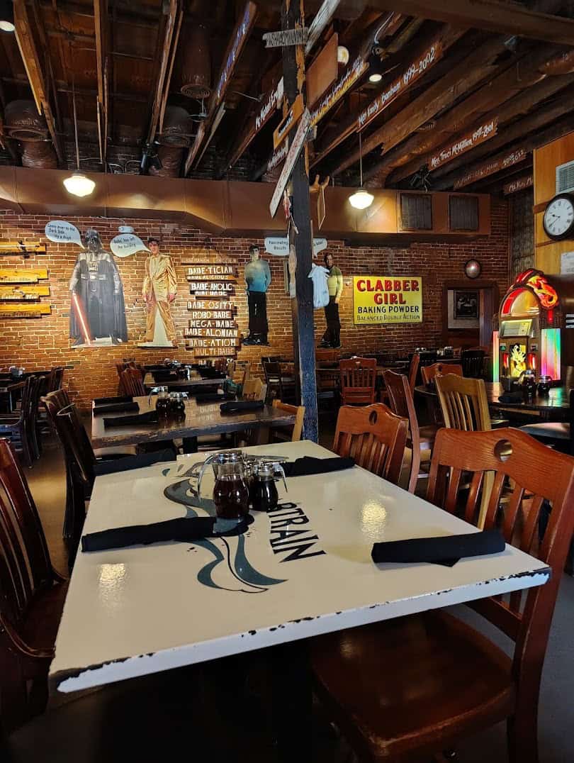 Long family-style dining tables set at Babe's Chicken Dinner House in Roanoke, Texas