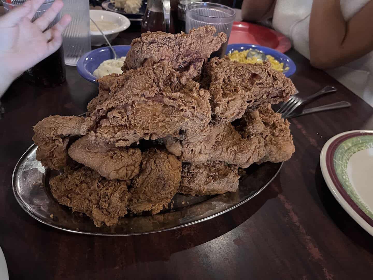 Pile of crispy fried chicken on a platter at Babe's Chicken Dinner House in Roanoke, Texas