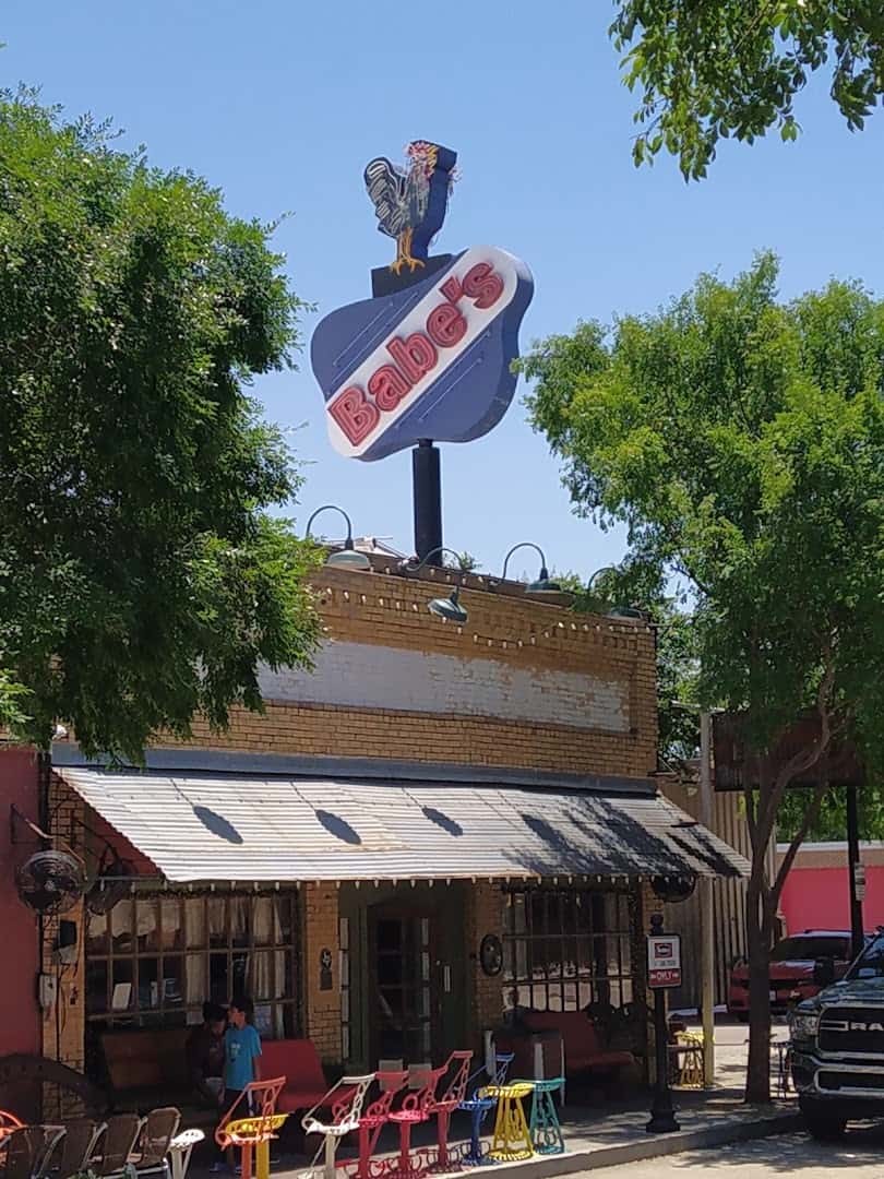 The original Babe's Chicken Dinner House sign and downtown storefront in Roanoke, Texas