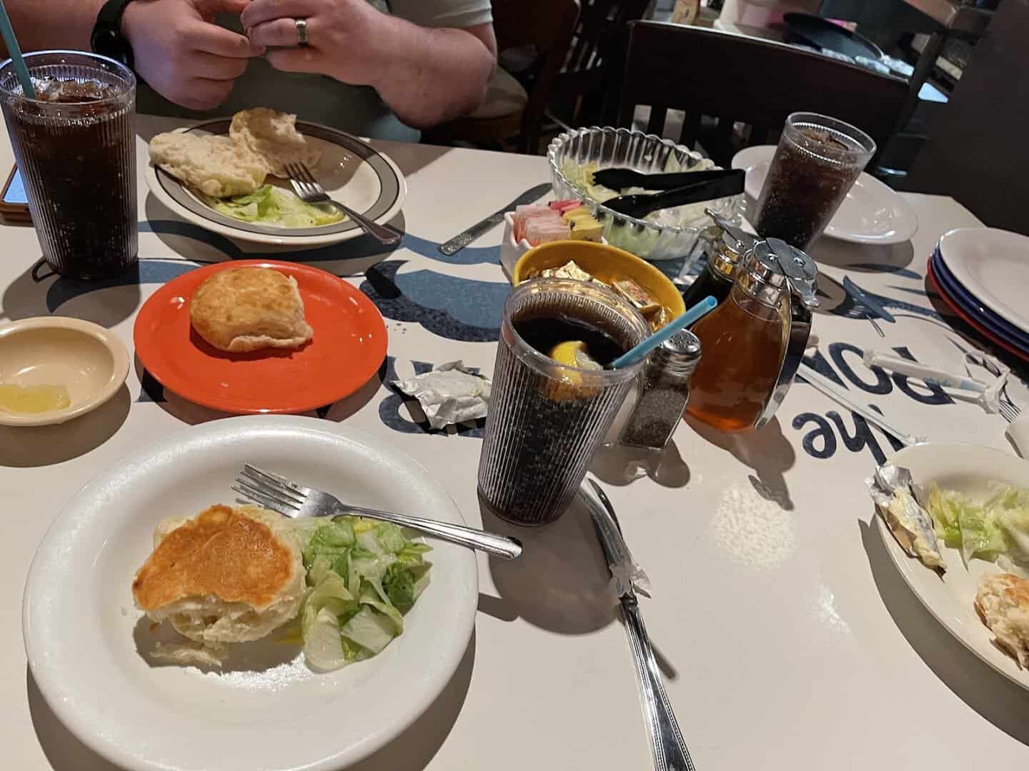 Family-style plate with a breaded cutlet, biscuit and cream gravy at Babe's Chicken Dinner House in Roanoke, Texas