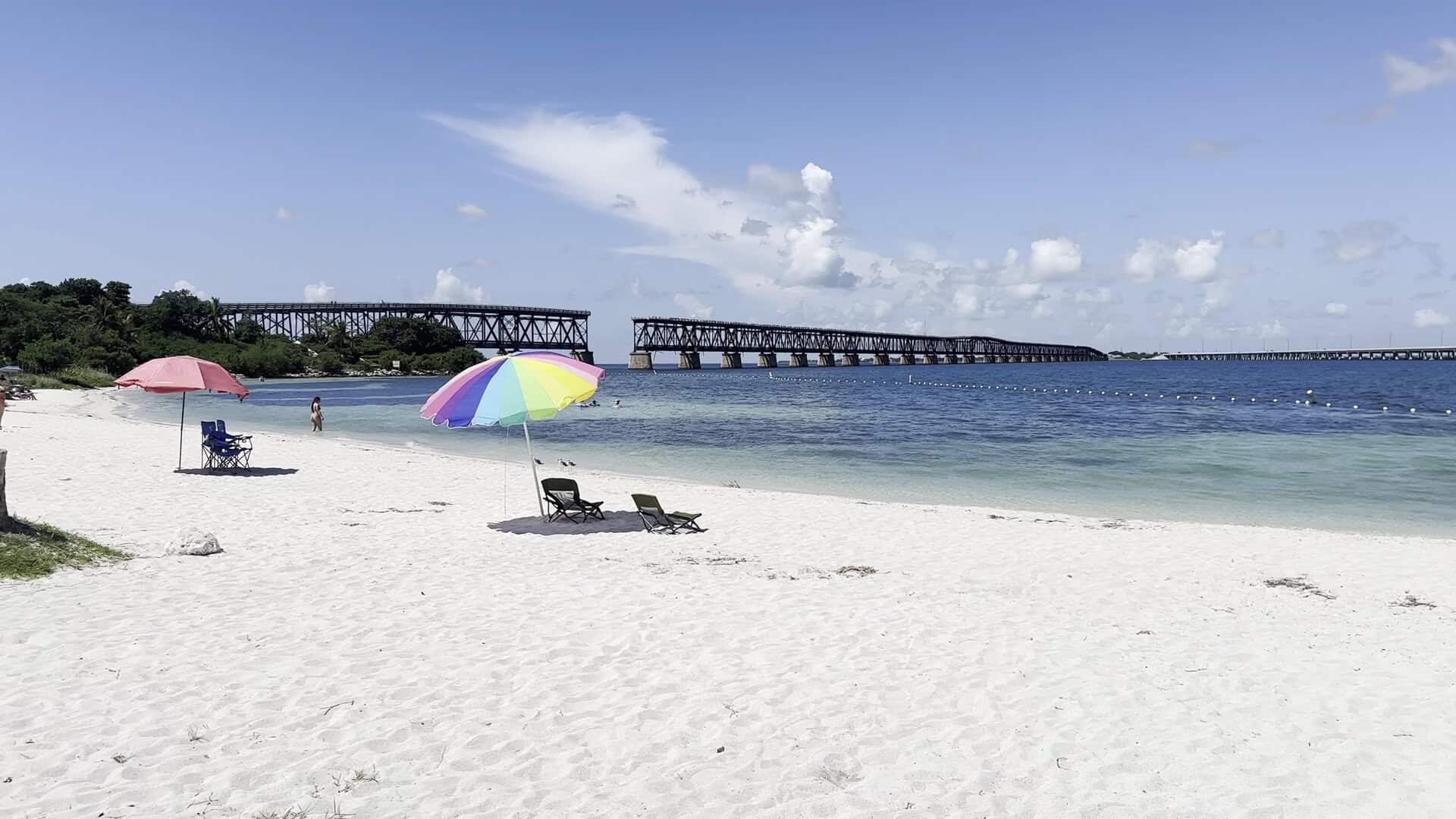 White sand beach and old bridge over turquoise water at Bahia Honda State Park, Florida Keys