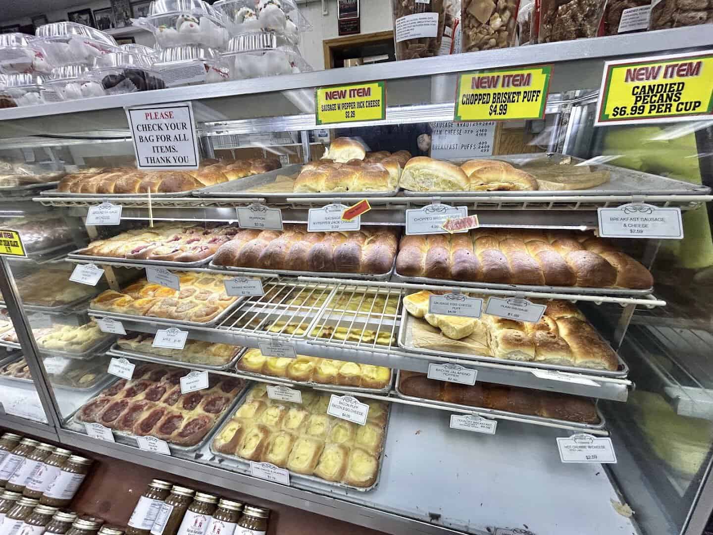 A bakery display case packed with kolaches and pastries at Czech Stop in West, Texas