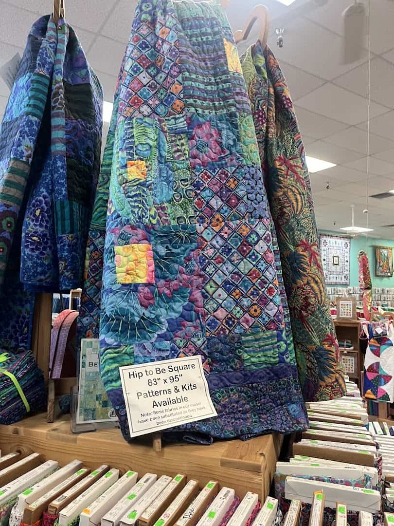 Rich blue batik quilts on display at Quilt Country in Lewisville, Texas