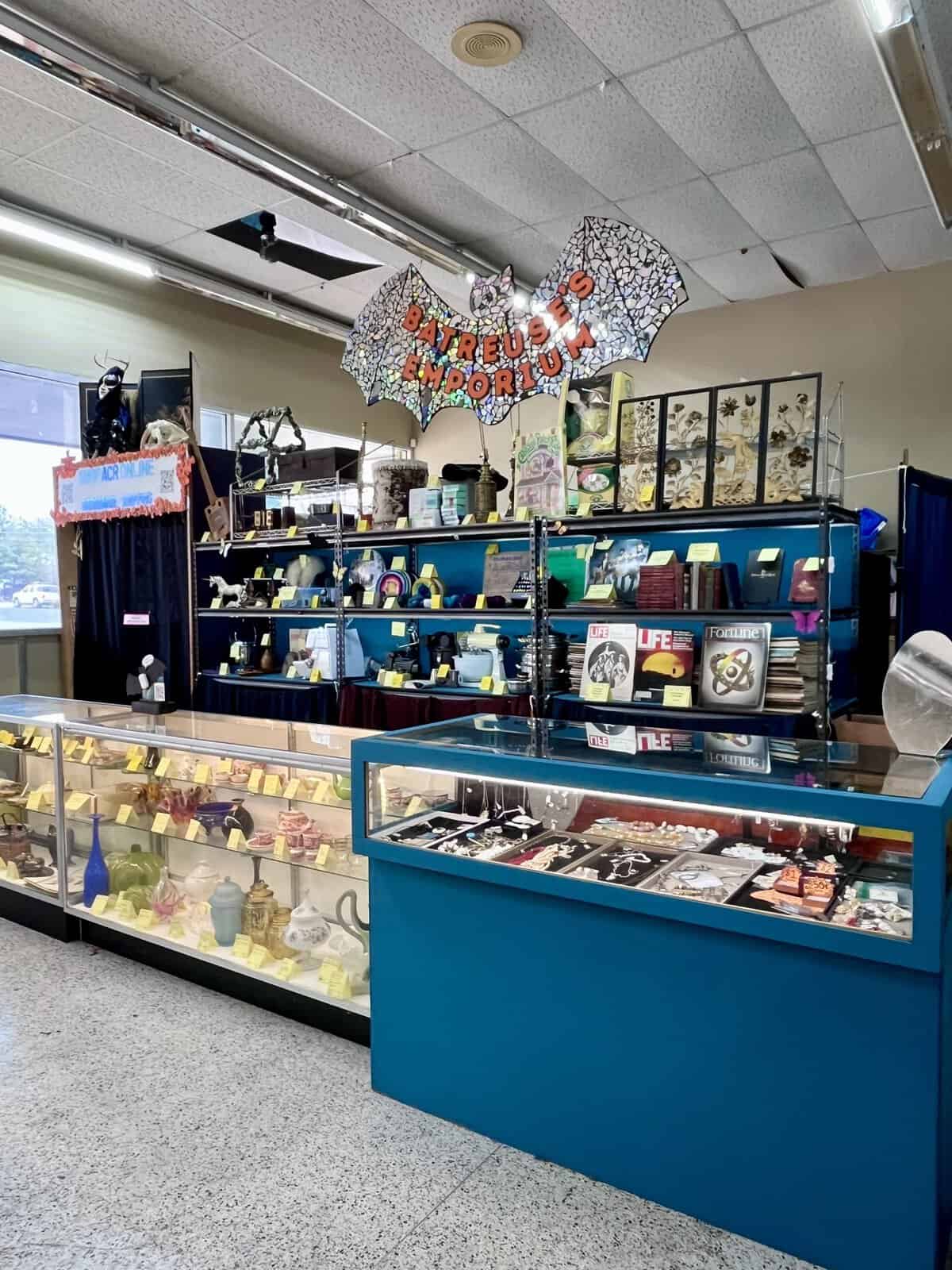 Glass display cases of curiosities in Batreuse's Emporium at Austin Creative Reuse