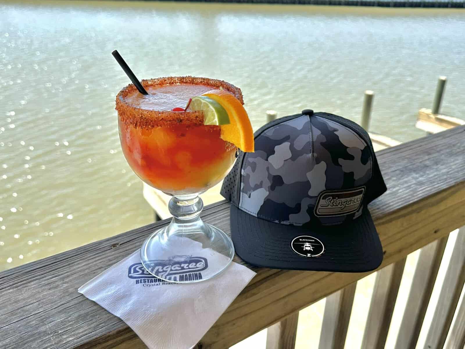 A cocktail on the deck rail overlooking the bay at Stingaree in Crystal Beach