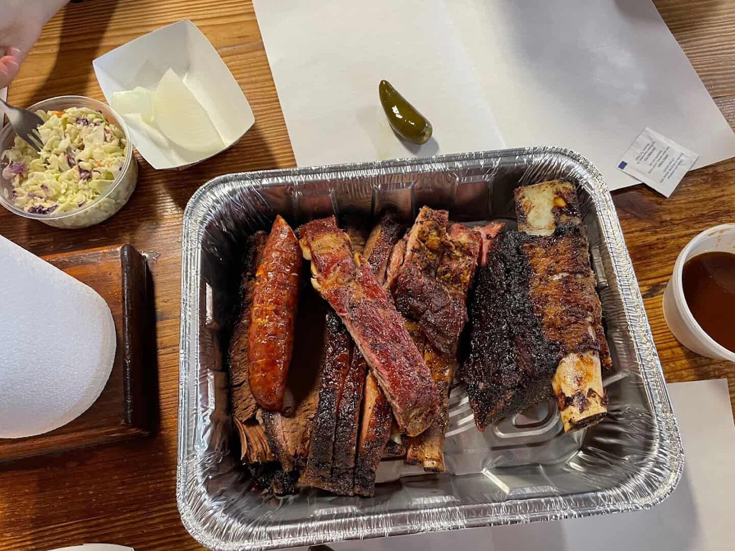 Tray of ribs, sausage and brisket with coleslaw at Cooper's in Fort Worth