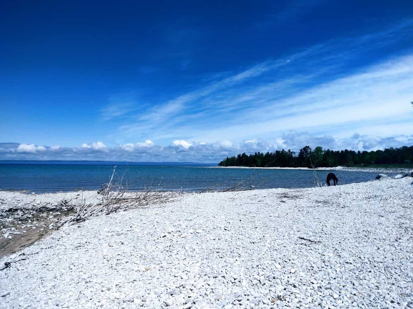 White pebble beach and clear blue water along the shore of Beaver Island in Lake Michigan