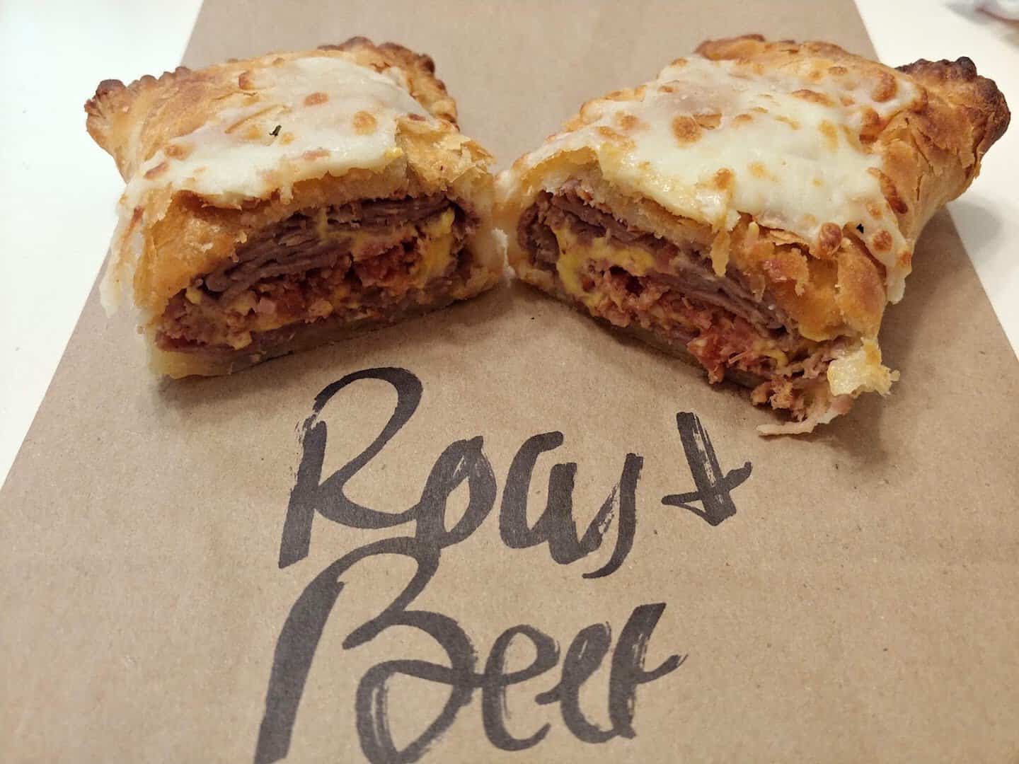 A beef and cheese croissant cut open at The Original Kolache Shoppe in Houston