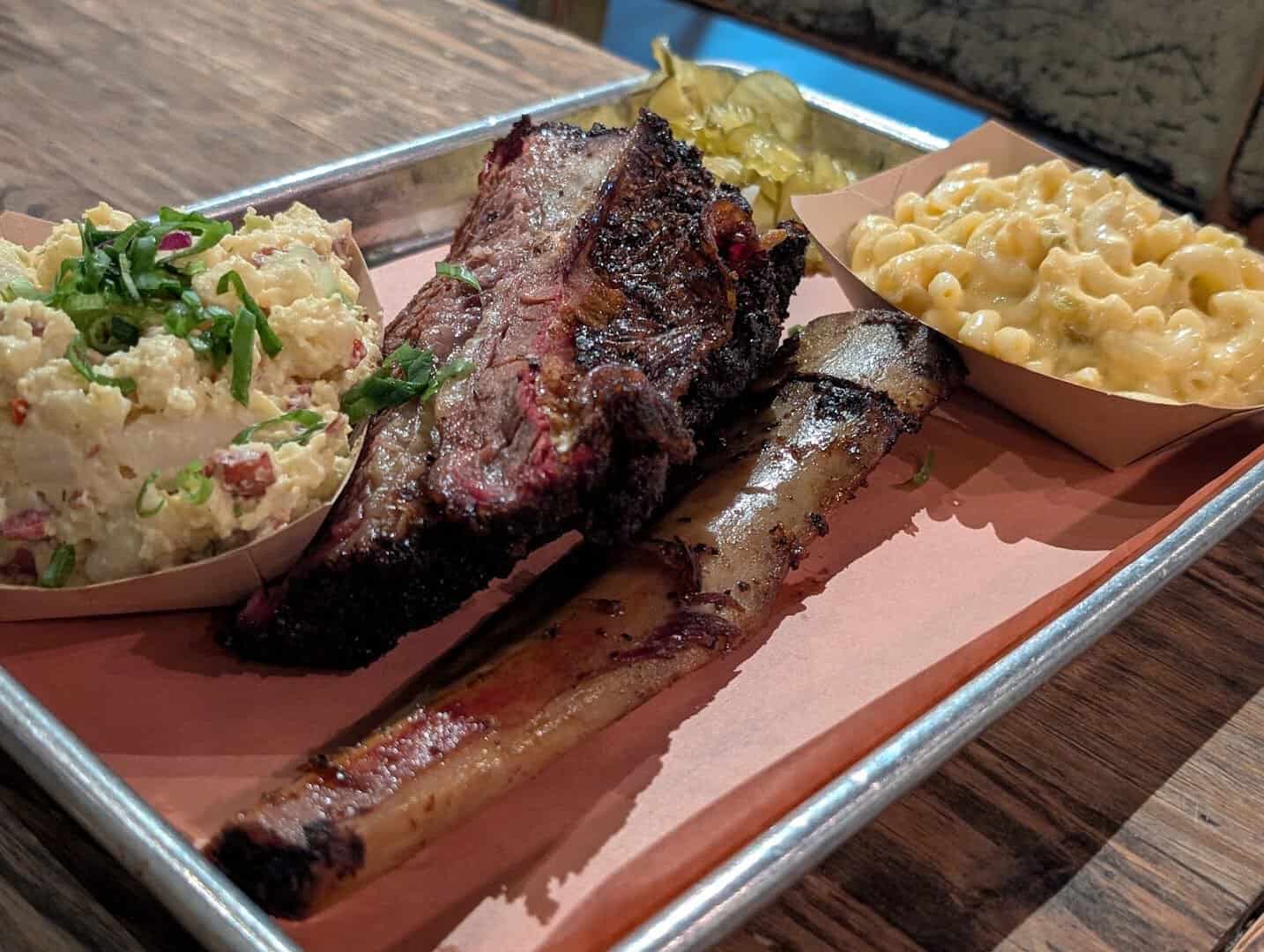 Barbecue tray with a beef rib, mac and cheese and potato salad at Pecan Lodge in Dallas