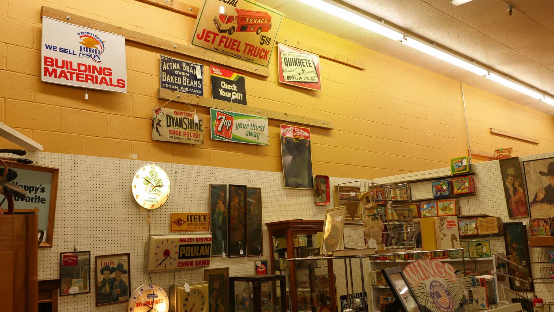 Wall of vintage advertising signs at Benbrook Antique Mall in Benbrook, Texas