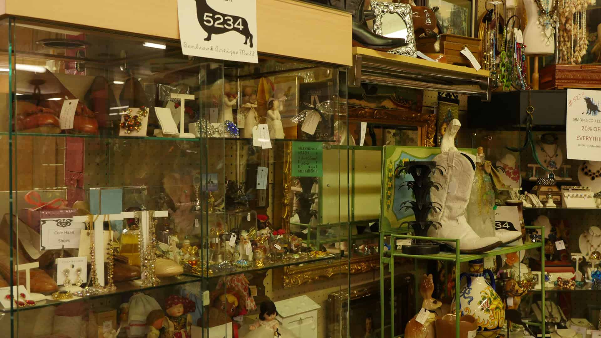 Glass display cases along an aisle at Benbrook Antique Mall in Benbrook, Texas