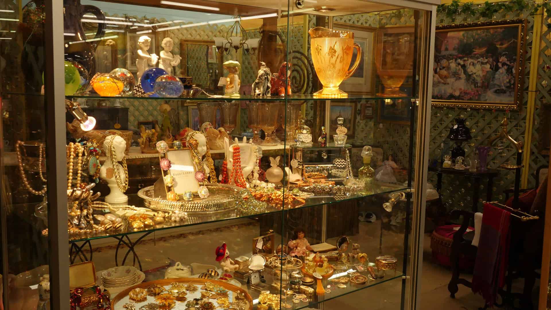 Glass case filled with vintage figurines and collectibles at Benbrook Antique Mall in Benbrook, Texas