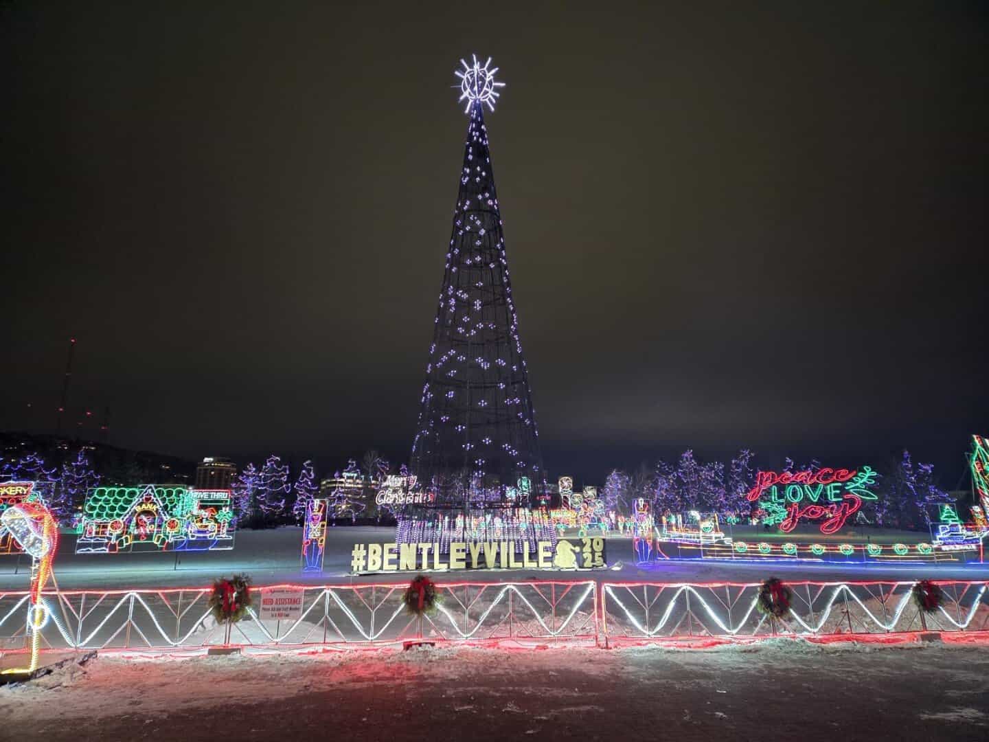 Illuminated Christmas tree and Bentleyville sign at night at the Bentleyville Tour of Lights in Duluth, Minnesota