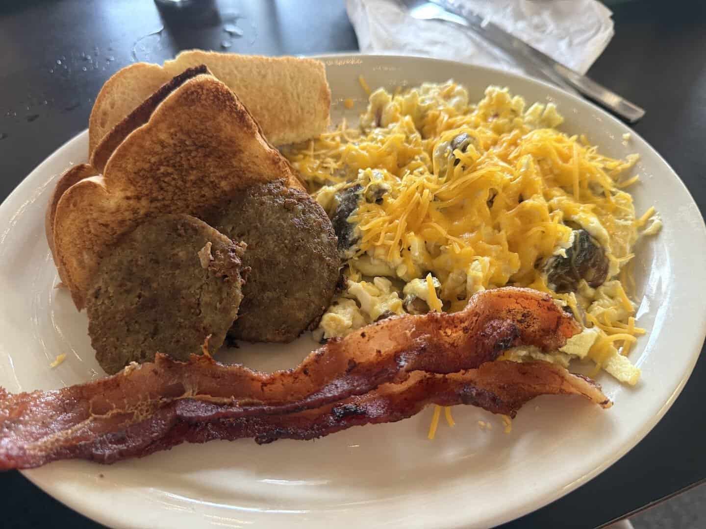 Breakfast plate with eggs, sausage, bacon, and toast at Beverly's Country Cafe in Jacksonville