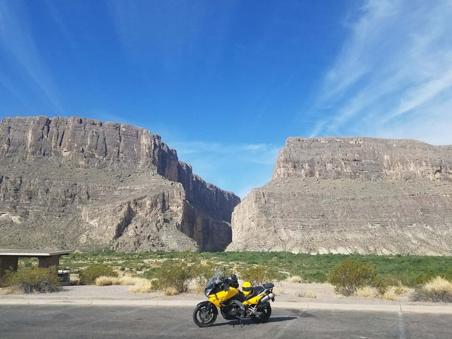 A motorcycle parked before the cliffs of Santa Elena Canyon in Big Bend National Park