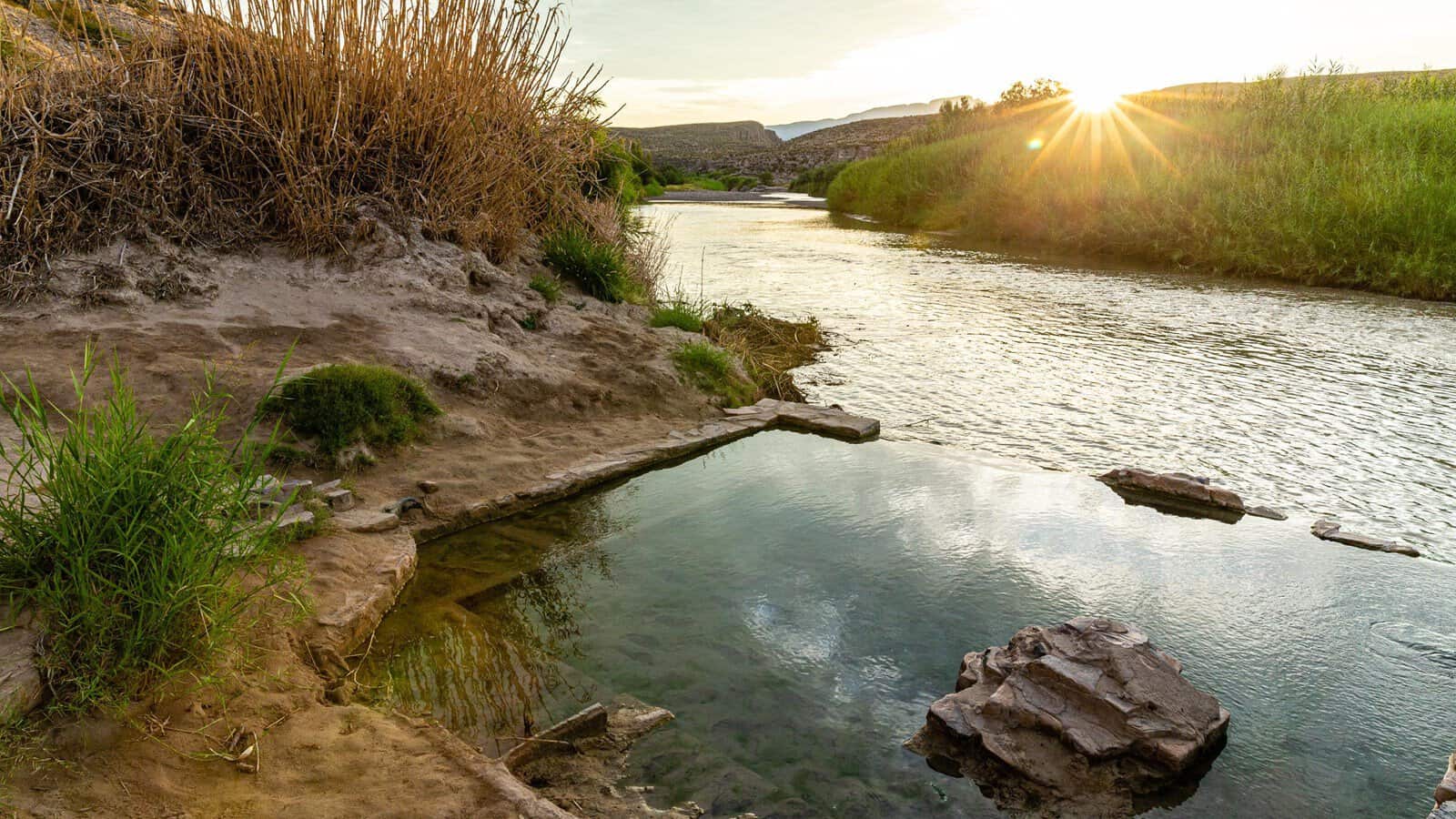 Golden-hour light over the Rio Grande and hot springs pool at Big Bend