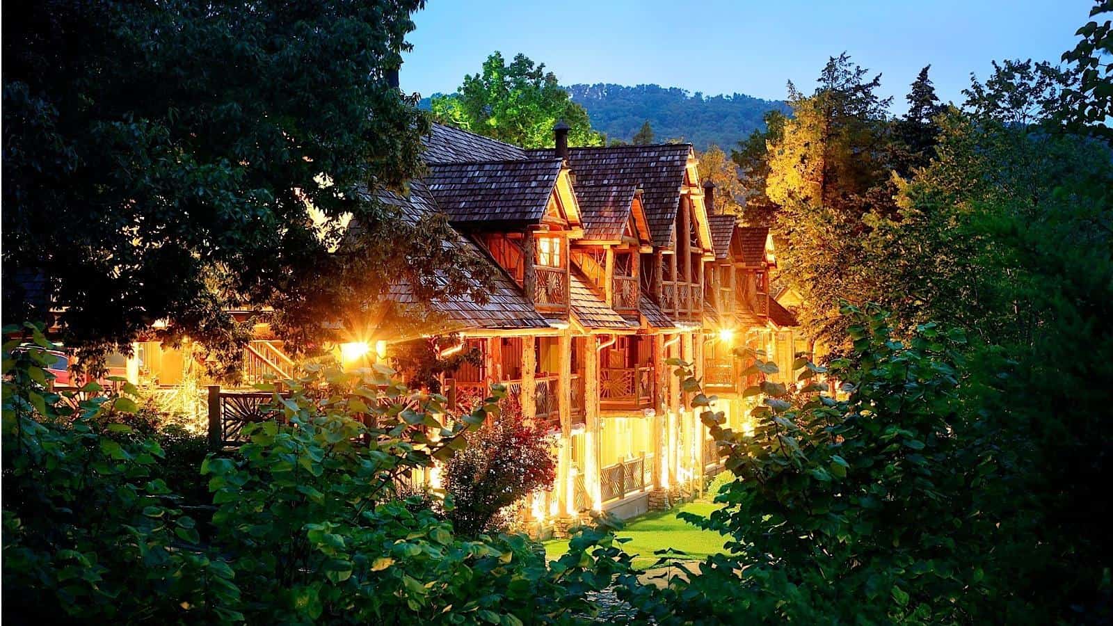 Log lodge exterior lit at dusk at Big Cedar Lodge in Ridgedale, Missouri