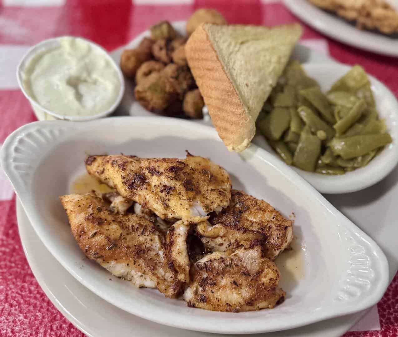 Plate of blackened chicken with green beans and hushpuppies at Texan Cafe and Pie Shop in Hutto, Texas