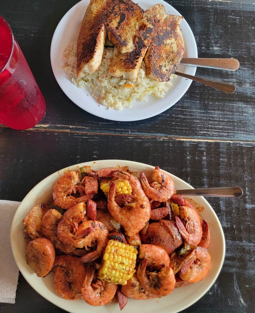 Blackened fish over rice beside a shrimp boil at Fish Shack in Plano, Texas