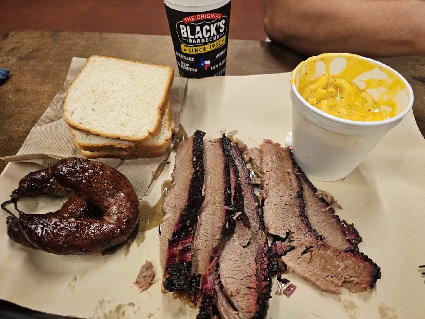 Brisket, sausage ring and white bread on butcher paper at Black's Barbecue in Lockhart, Texas