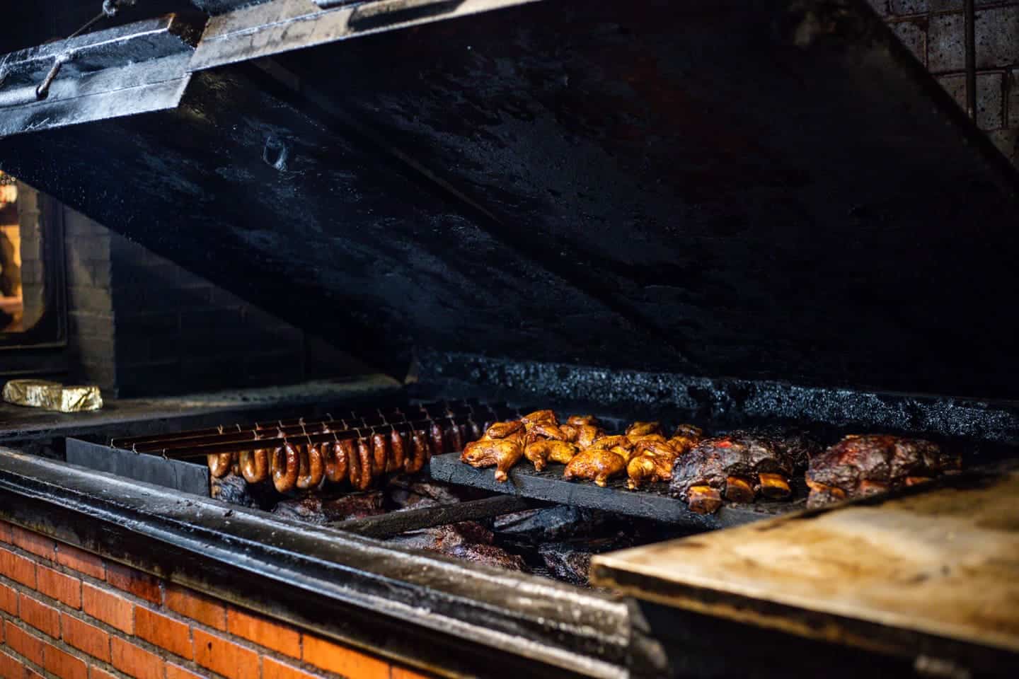 Sausage links smoking on the pit at Black's Barbecue in Lockhart, Texas