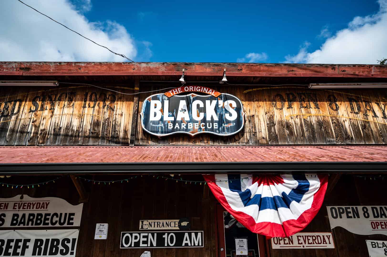 The weathered wood storefront and sign at Black's Barbecue in Lockhart, Texas