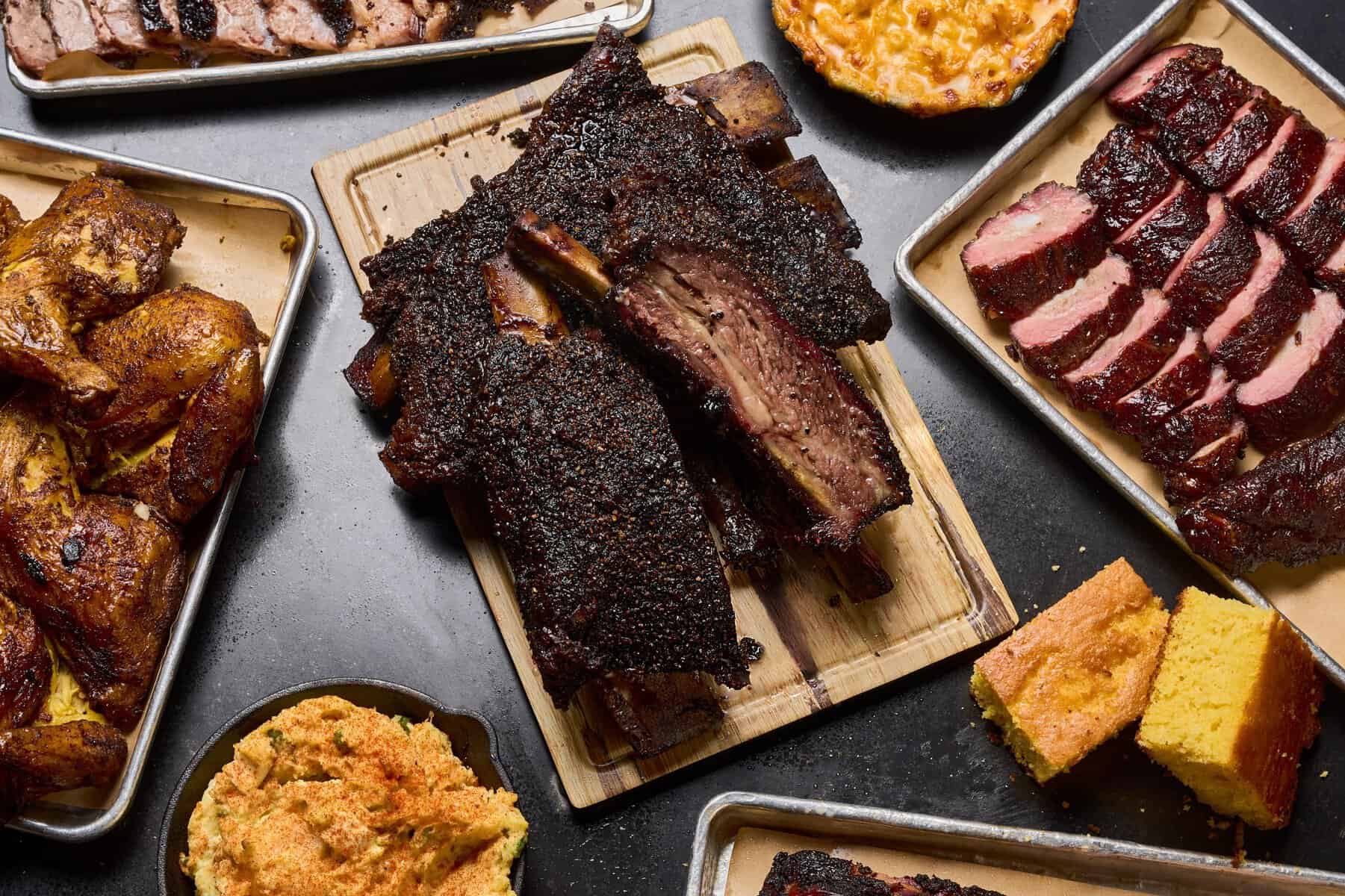 Spread of brisket, ribs and sides at Bludso's BBQ in Los Angeles, California