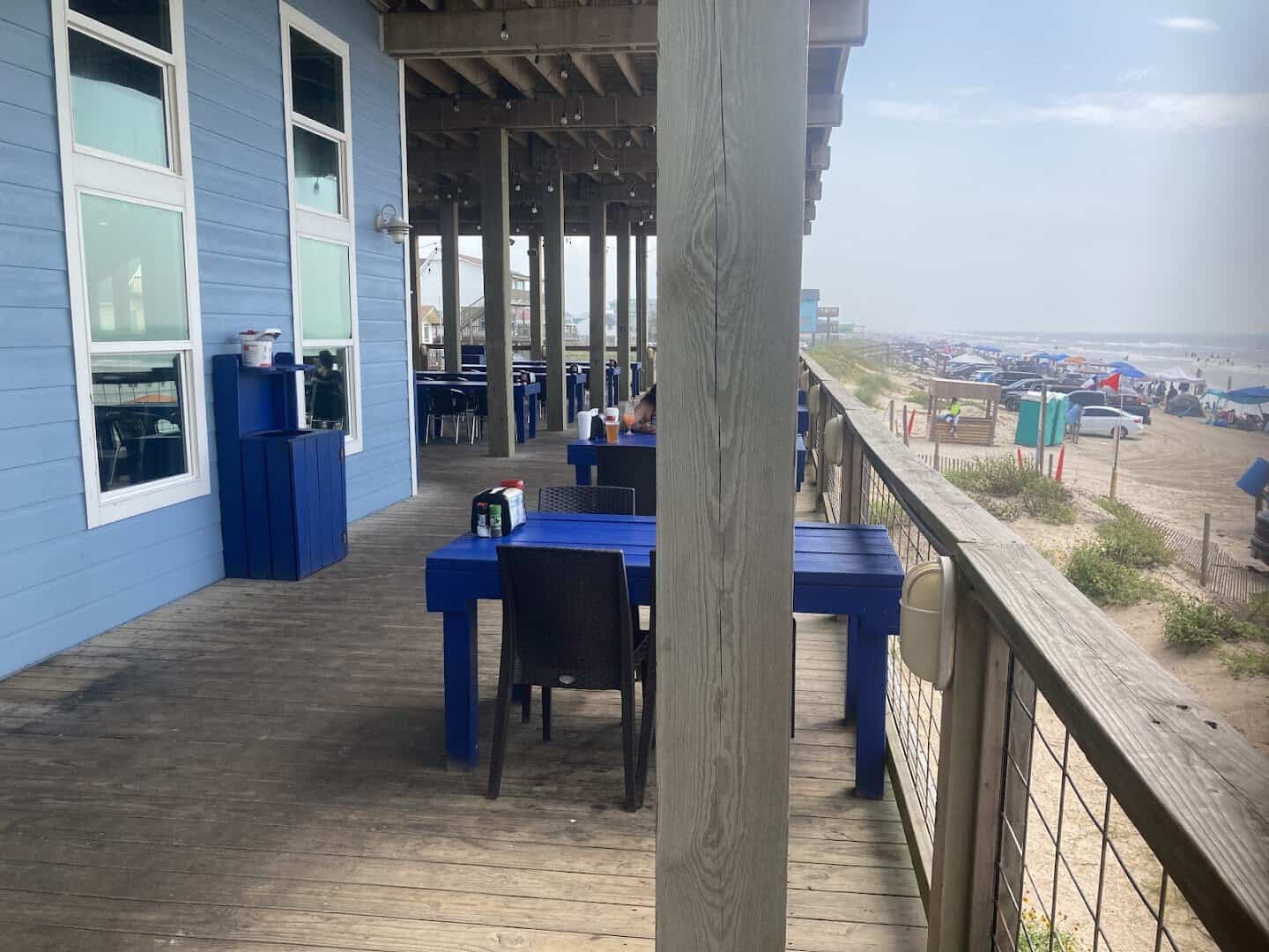 Blue clapboard exterior and deck at Seahorse Bar and Grill in Surfside Beach, Texas
