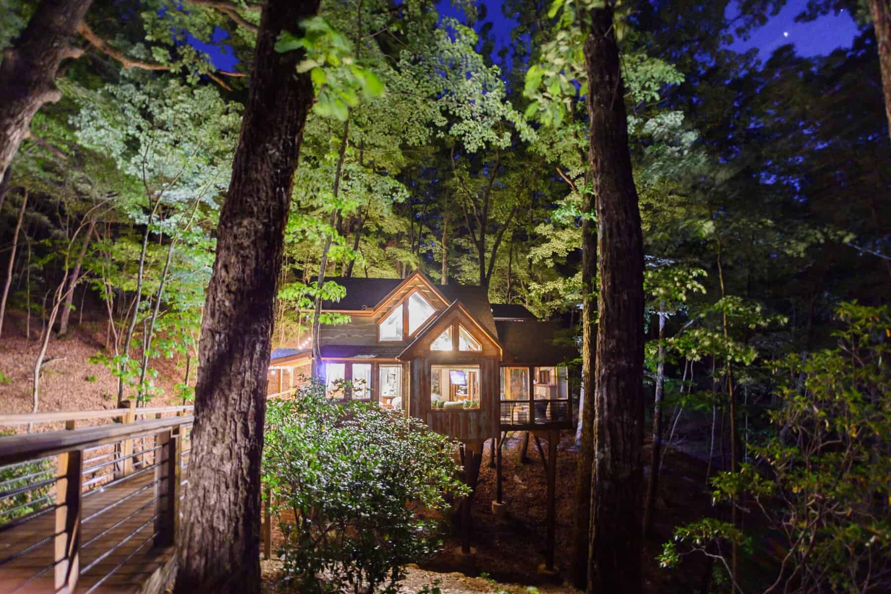 Illuminated treehouse in the forest at Blue Ridge Treehouse Rentals in Georgia
