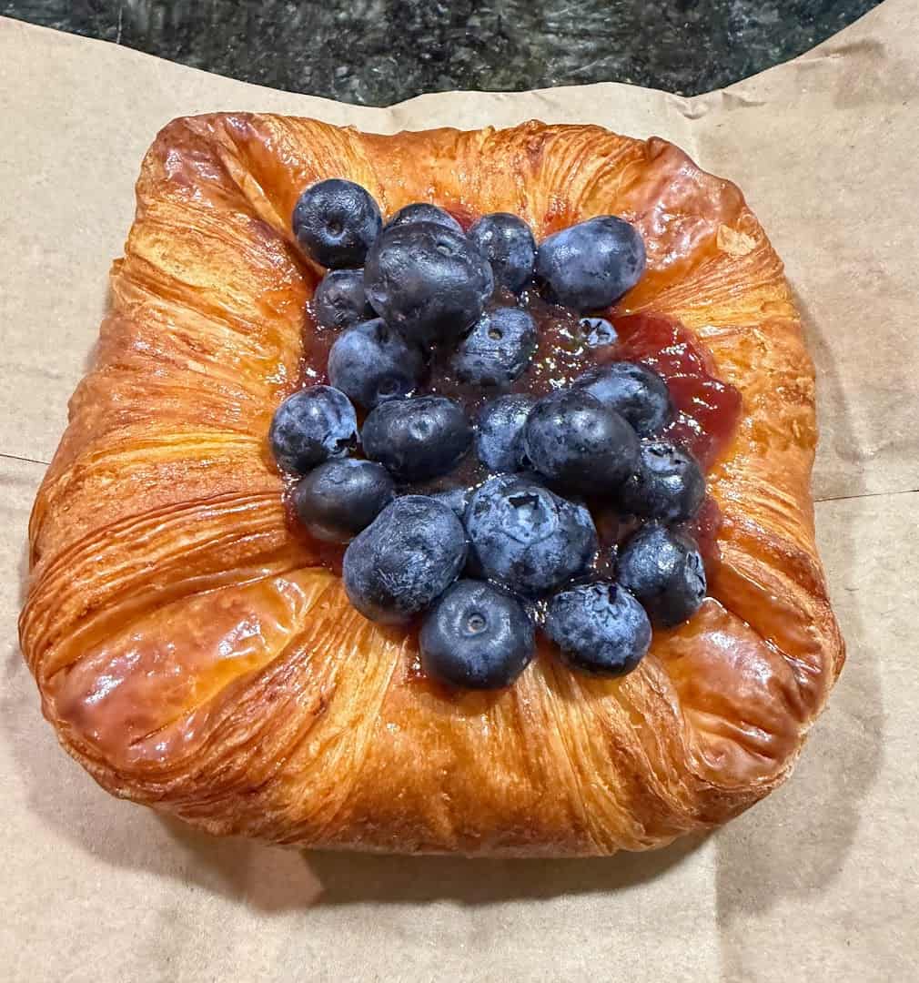 A glossy blueberry-topped danish at Artisana Bread in Houston, Texas