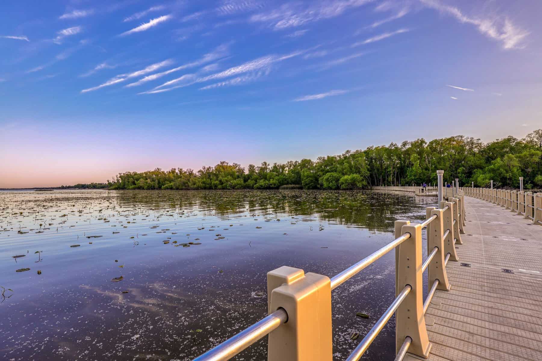 Floating boardwalk deck with railings along the water at golden hour, Lake Weatherford, Weatherford Texas